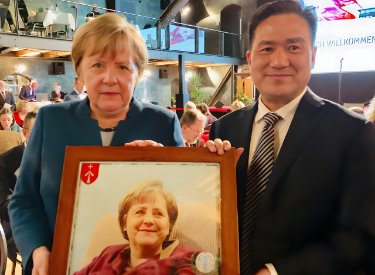 Former German Chancellor Angela Merkel and GASME Secretary-General Frank Cao